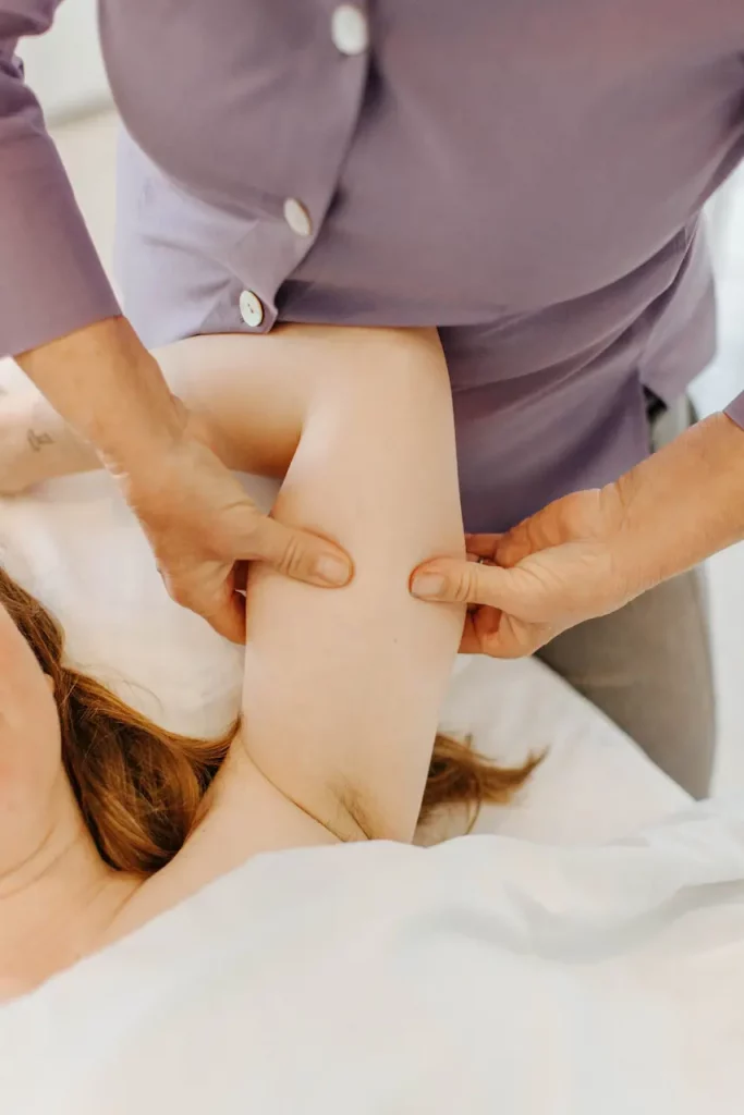 Physical therapist working on a patient's arm at the West Cliff clinic, serving Santa Cruz and Monterey.