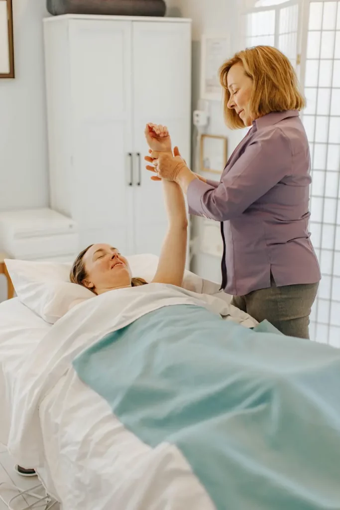 Certified physical therapist performing arm mobility exercise on a patient at West Cliff Lymphatics in Santa Cruz, CA.